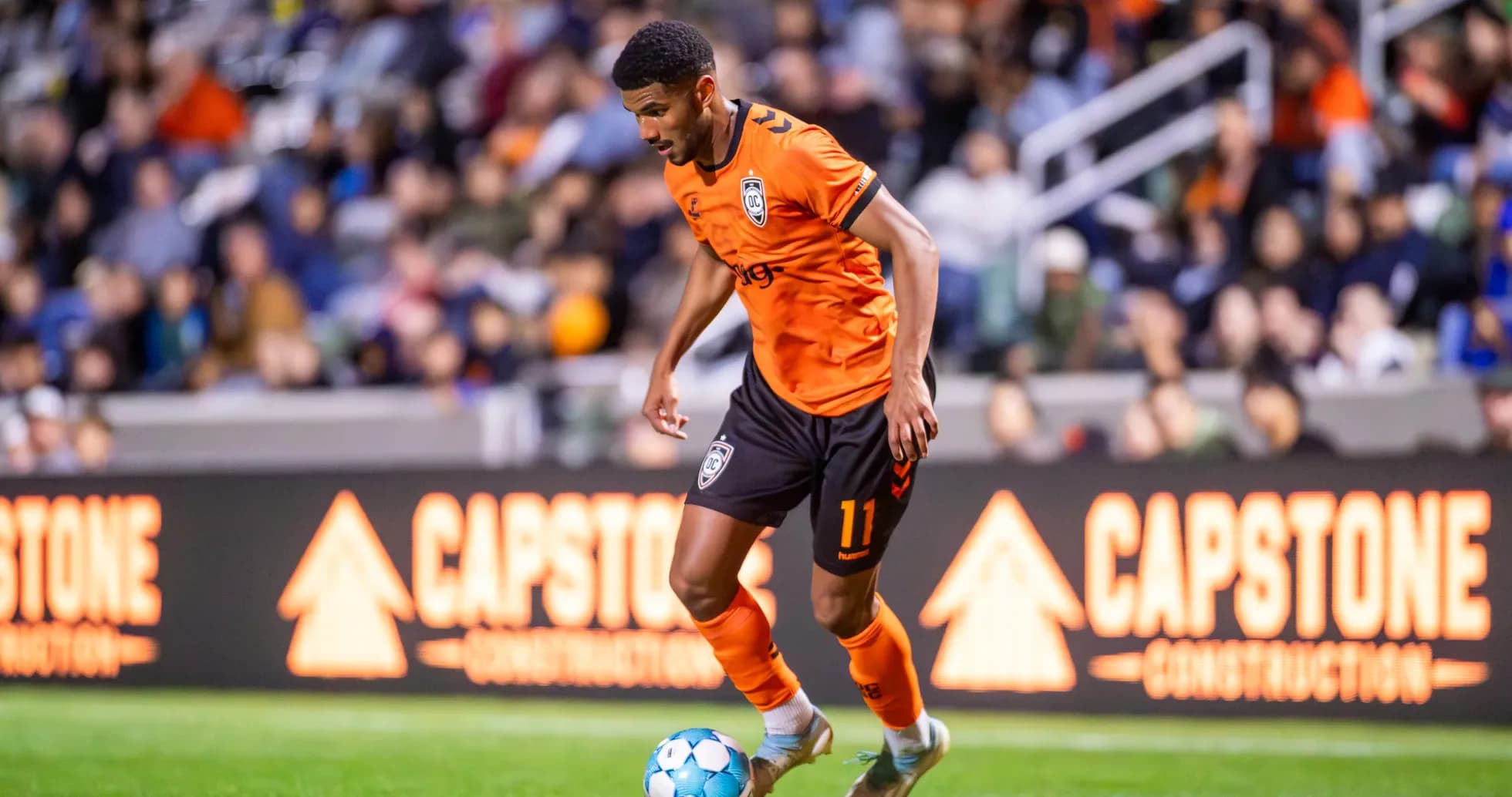 Player dribbling the ball in football match