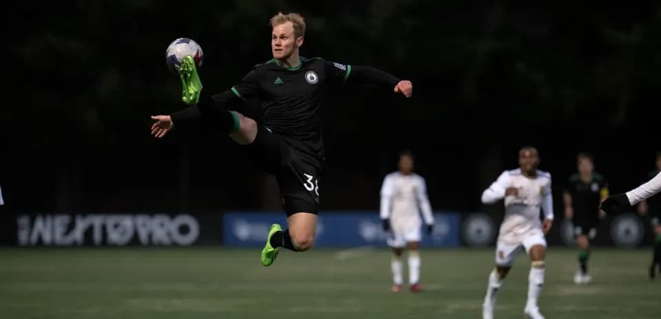 Player jumping to intercept the ball during match