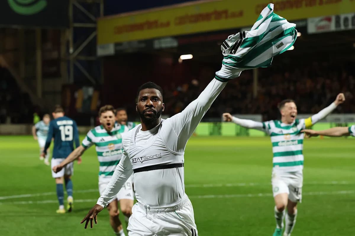 Player celebrating a goal with teammates in stadium