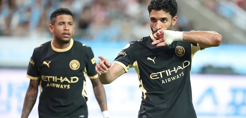 Player celebrating a goal with teammate nearby