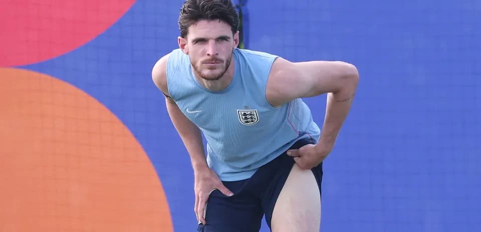 Player stretching during training session in England kit
