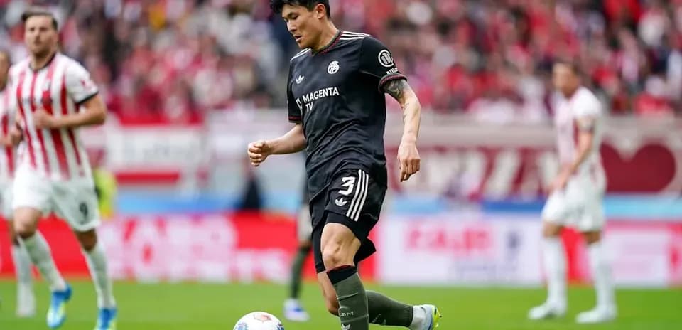 Player in black uniform dribbling ball during match