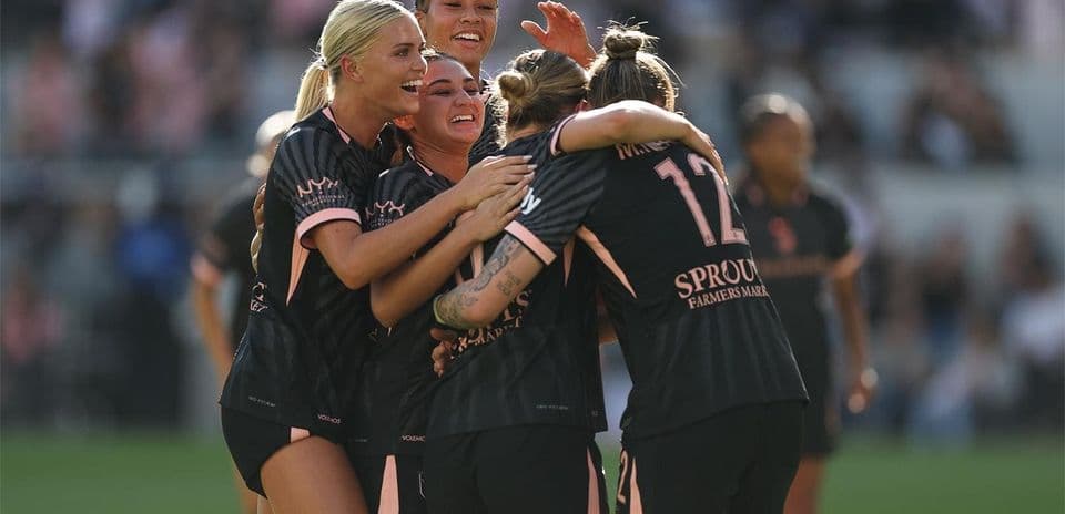 Players celebrating a goal during match