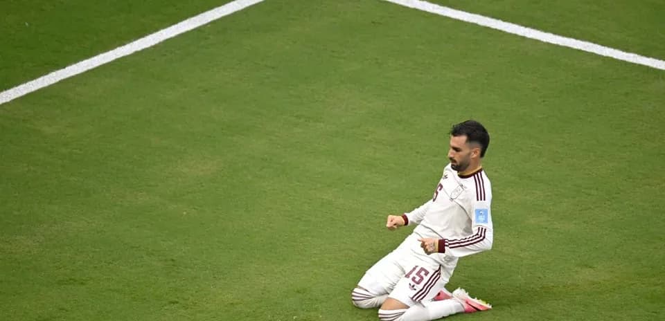 Player celebrating on the field after scoring