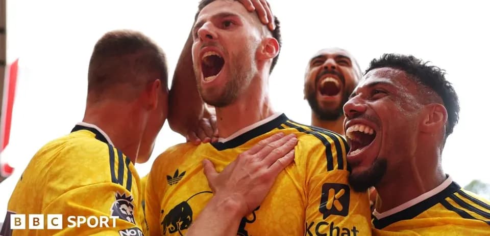 Players celebrating a goal with joyful expressions