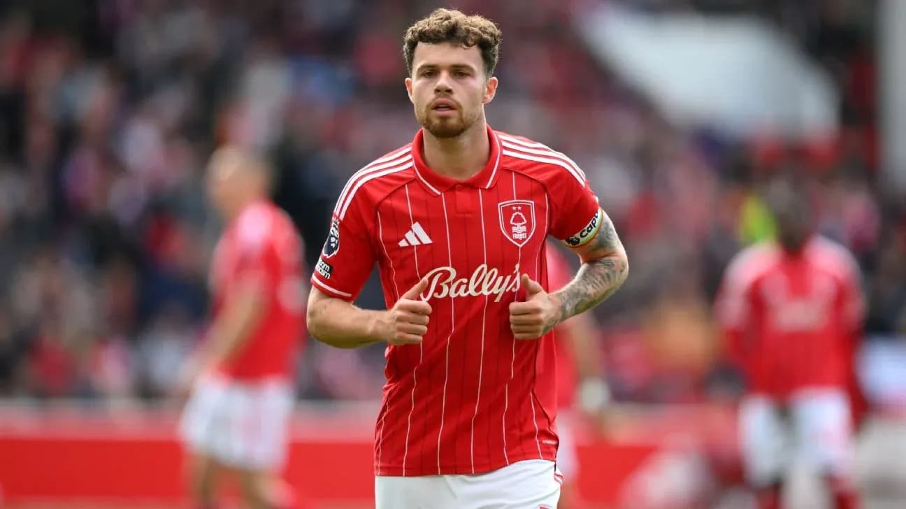 Player in red kit walking on the pitch