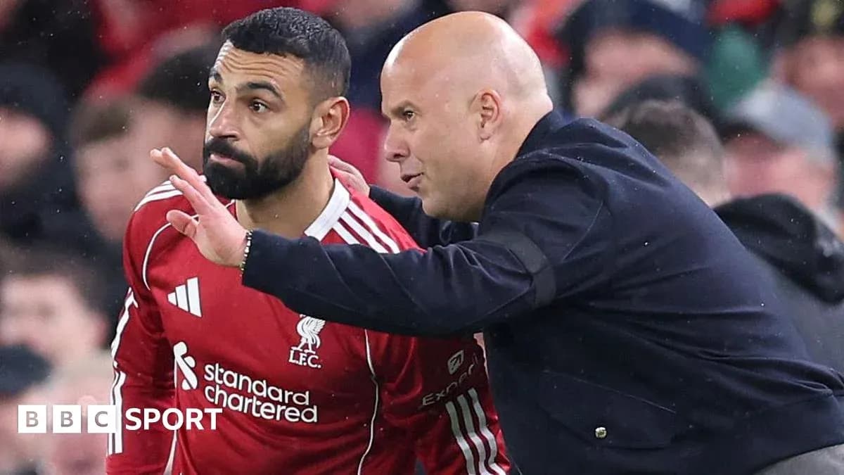 Player receiving instructions from coach on the sidelines