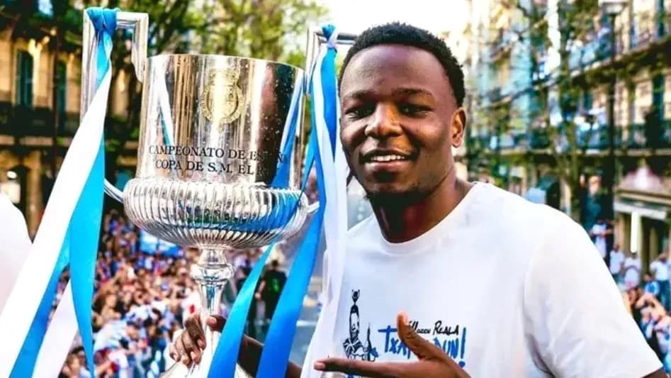 Player celebrating with trophy during victory parade