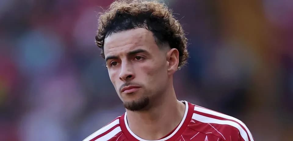 Player in red jersey looking serious on the field