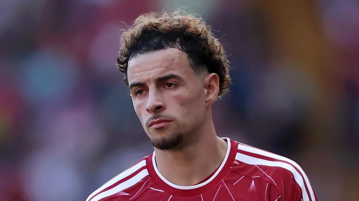 Player in red jersey looking serious on the field