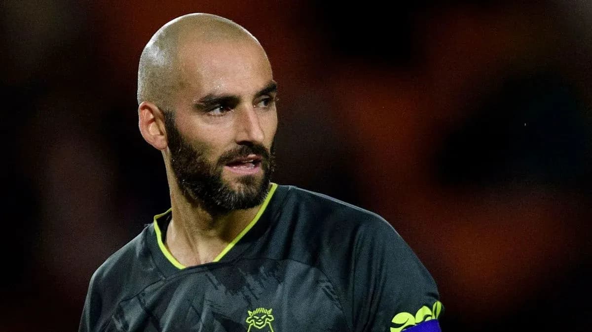Goalkeeper wearing a black kit with a captain's armband