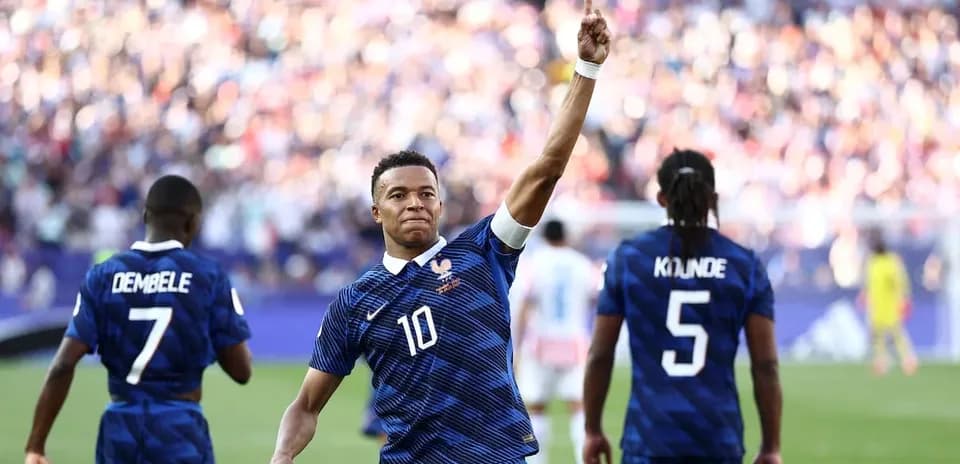Mbappé celebrating a goal with teammates during match