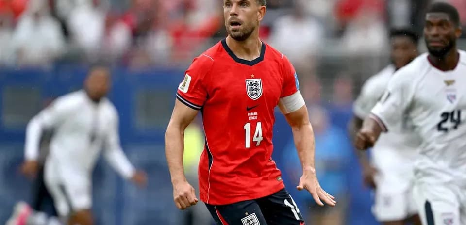 Player in red England kit during match action