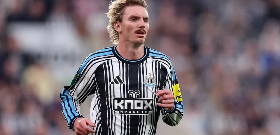 Newcastle player running during match at stadium
