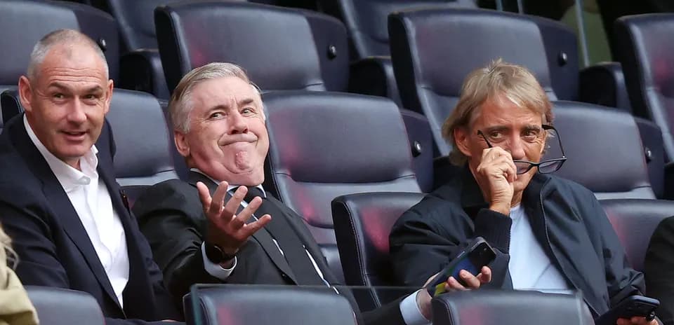 Three men sitting in stadium seats during event
