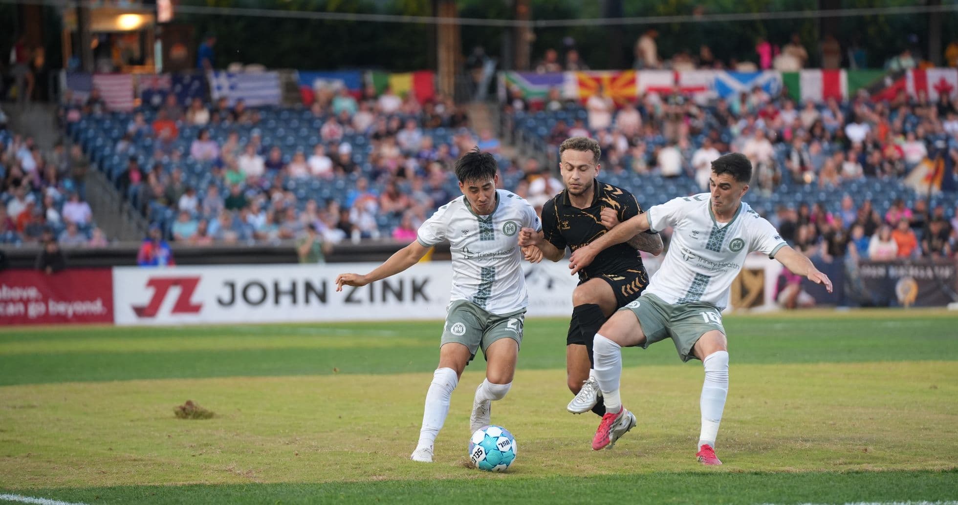 Players competing for the ball in USL match