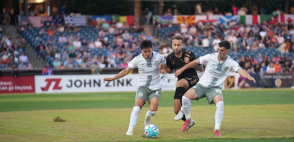 Players competing for the ball in USL match