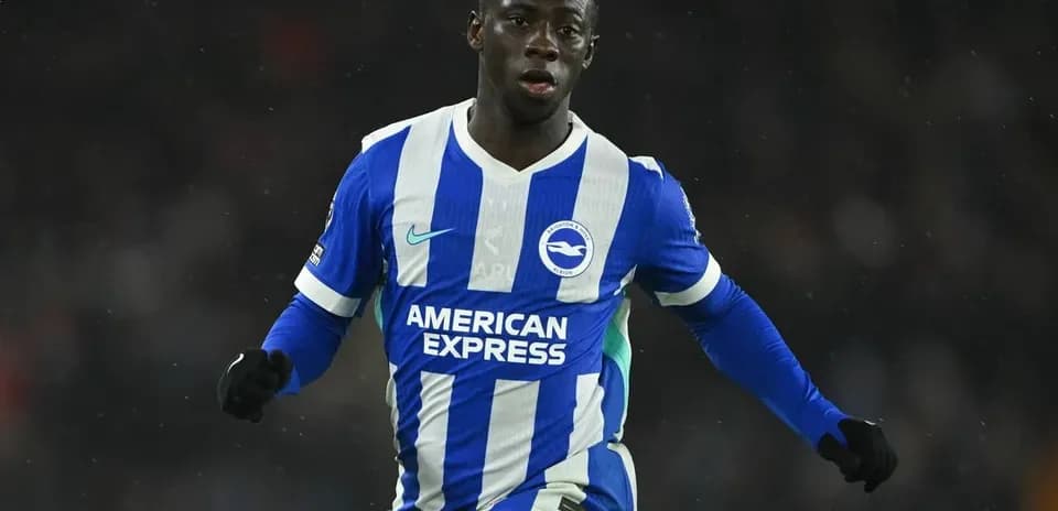 Player in blue and white kit celebrating on field