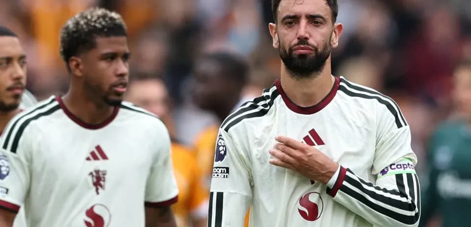 Two players walking off the field after match