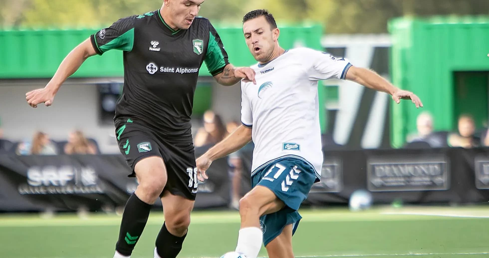 Two players competing for the ball in match