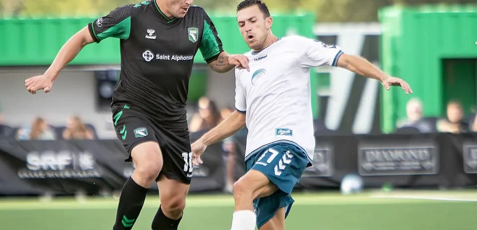 Two players competing for the ball in match