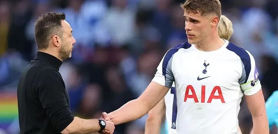 Coach shaking hands with Tottenham player after match