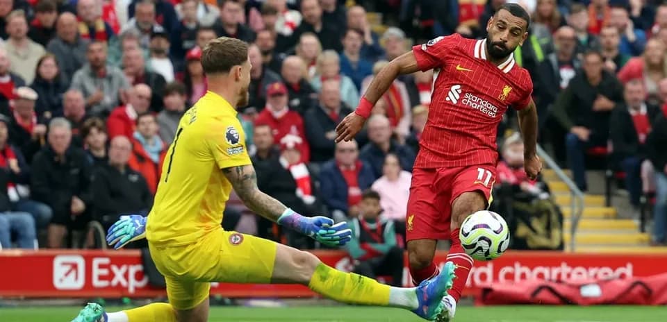 Liverpool player shooting on goal against Brentford