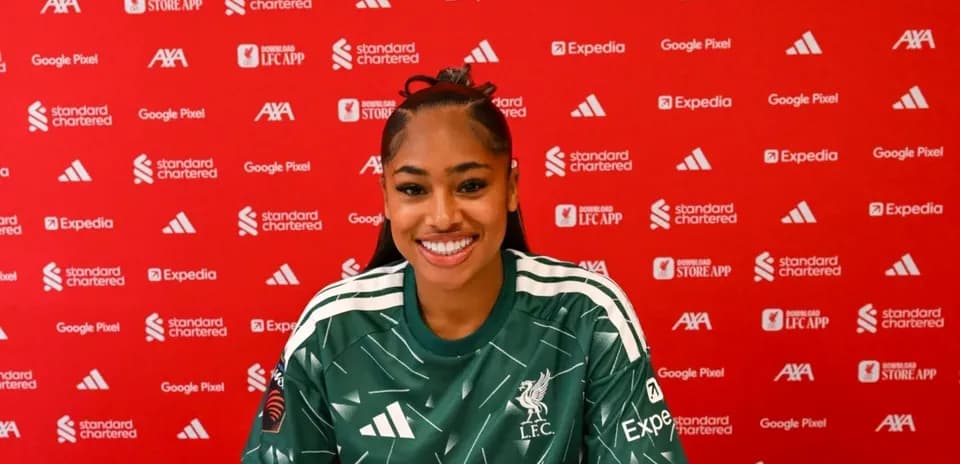 Player in Liverpool jersey at press conference