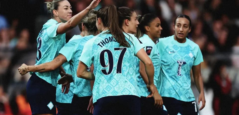 Players celebrating a goal on the pitch