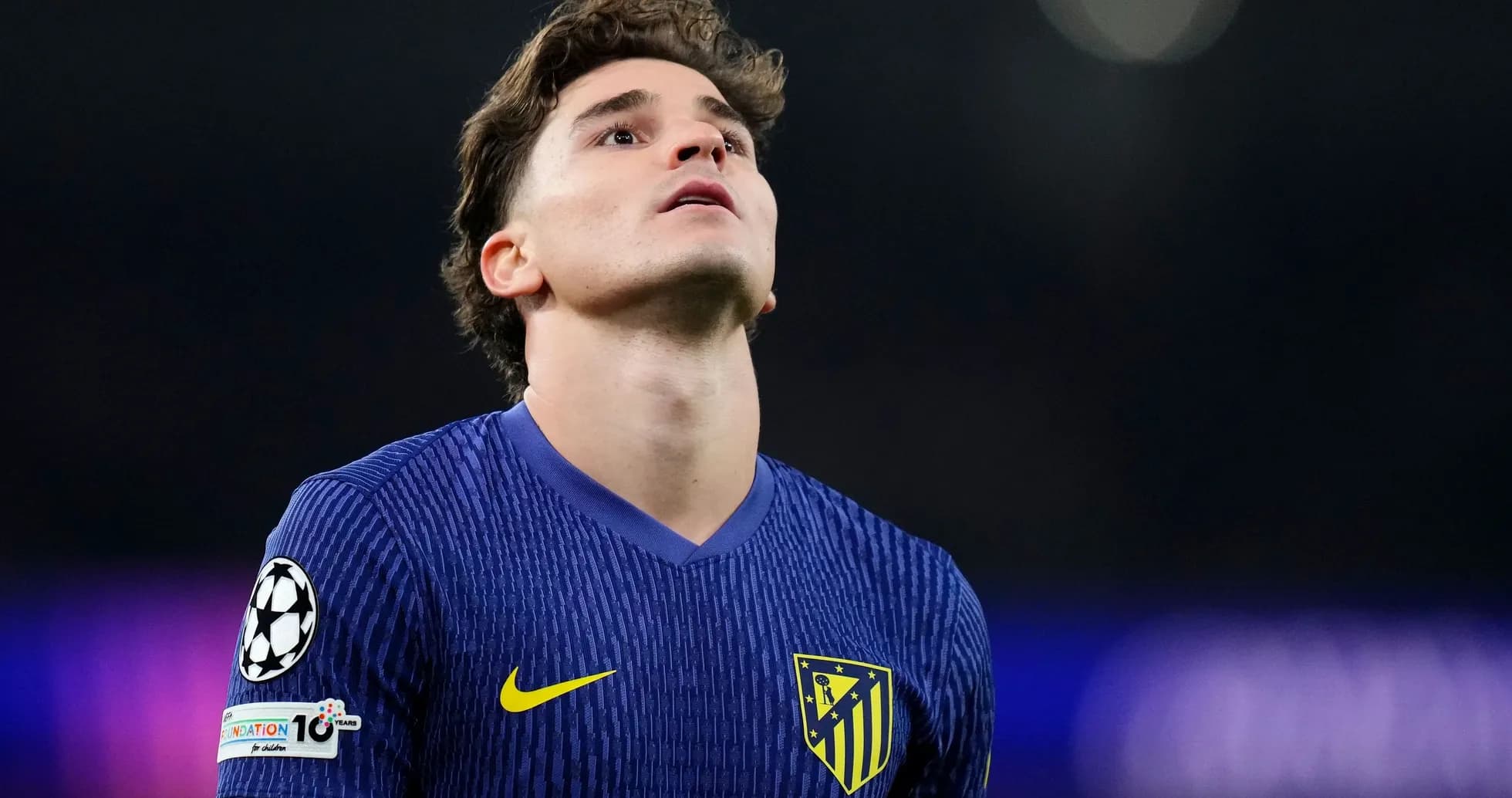 Player in Atletico Madrid jersey looking upwards