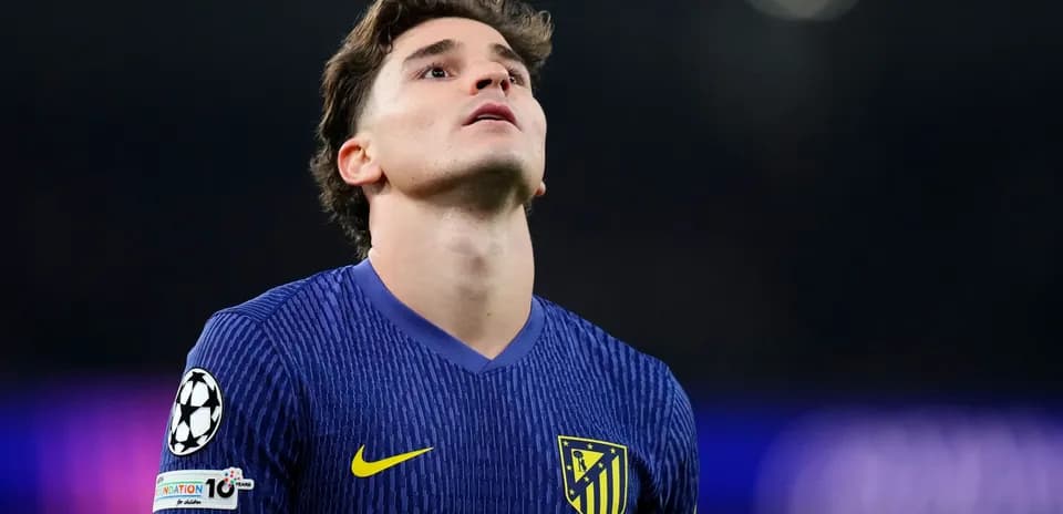 Player in Atletico Madrid jersey looking upwards