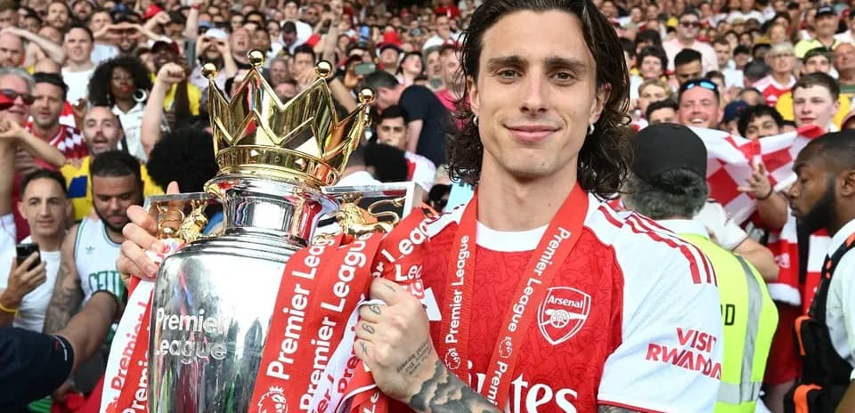 Player celebrating with Premier League trophy and fans