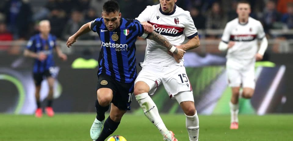 Inter player tackled by Bologna defender during match