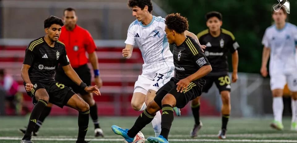 Players competing for the ball in MLS Next Pro