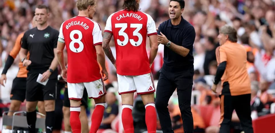 Arsenal players and manager discussing strategy during match