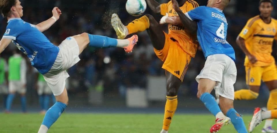 Players competing for the ball in Serie A match