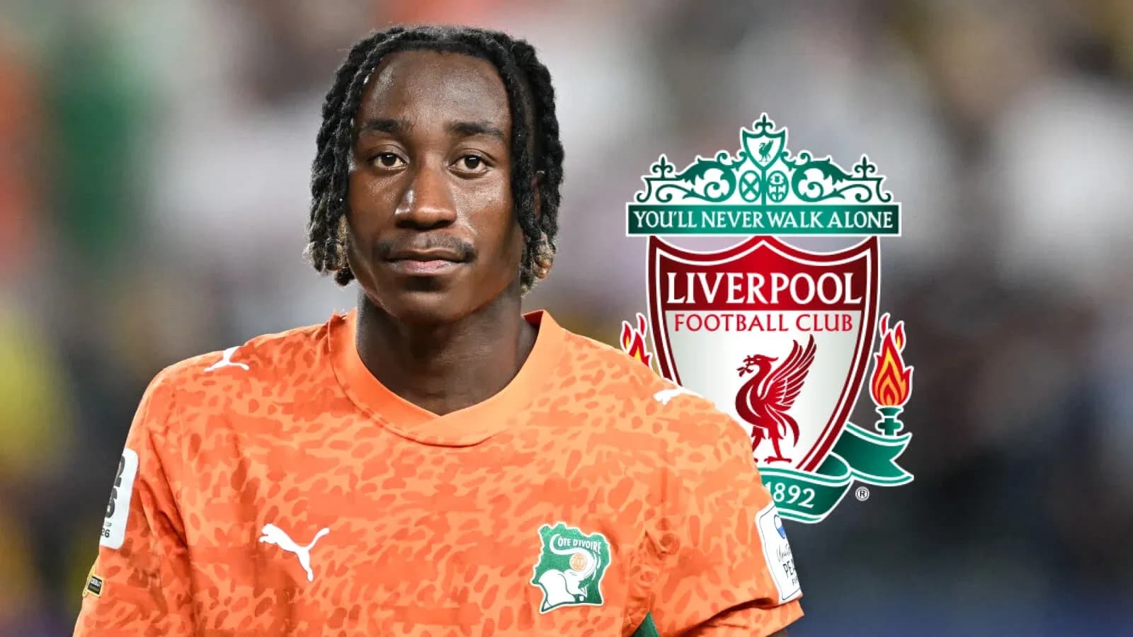 Goalkeeper in orange kit with Liverpool logo background