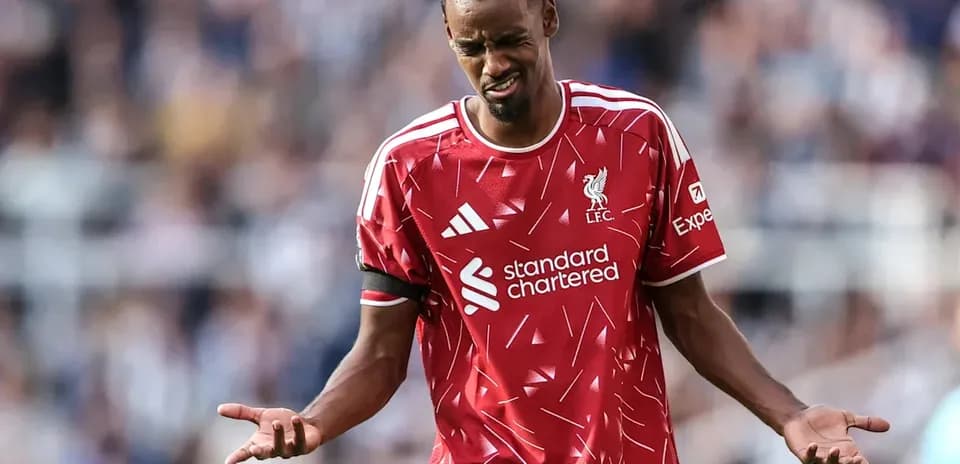 Liverpool player reacting during match with hands raised