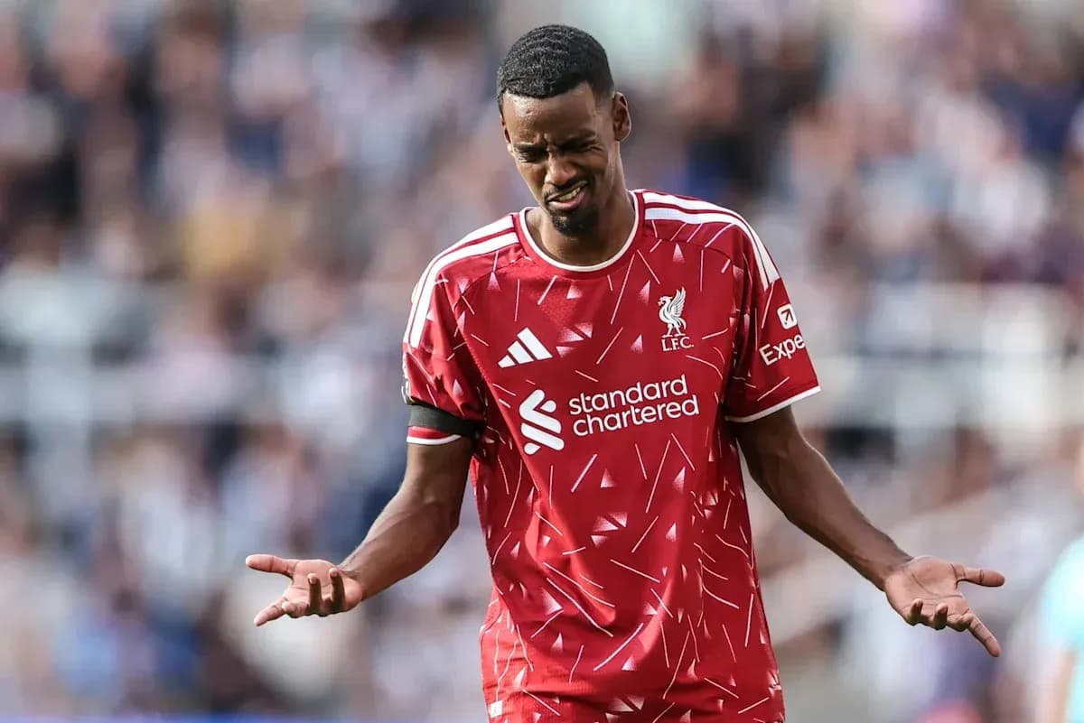 Liverpool player reacting during match with hands raised