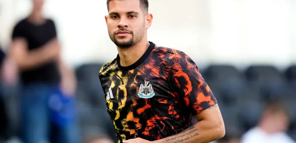 Player wearing Newcastle United training kit on pitch