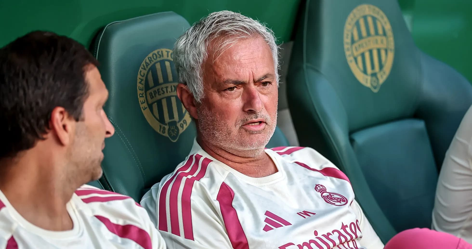 Manager discussing tactics on the bench during match