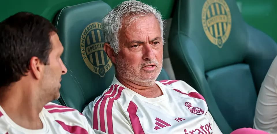 Manager discussing tactics on the bench during match