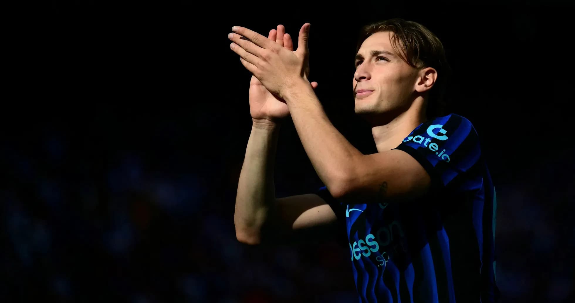 Player applauding fans in stadium during match