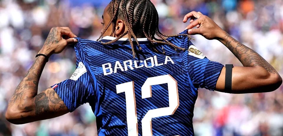 Player showcasing jersey with 'Barcola' and number 12