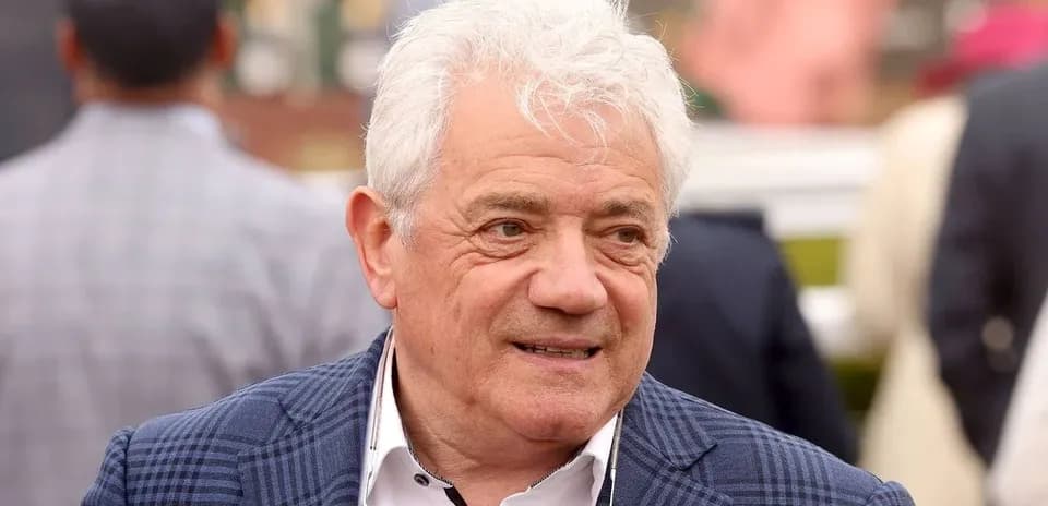 Man in a blazer at an outdoor event