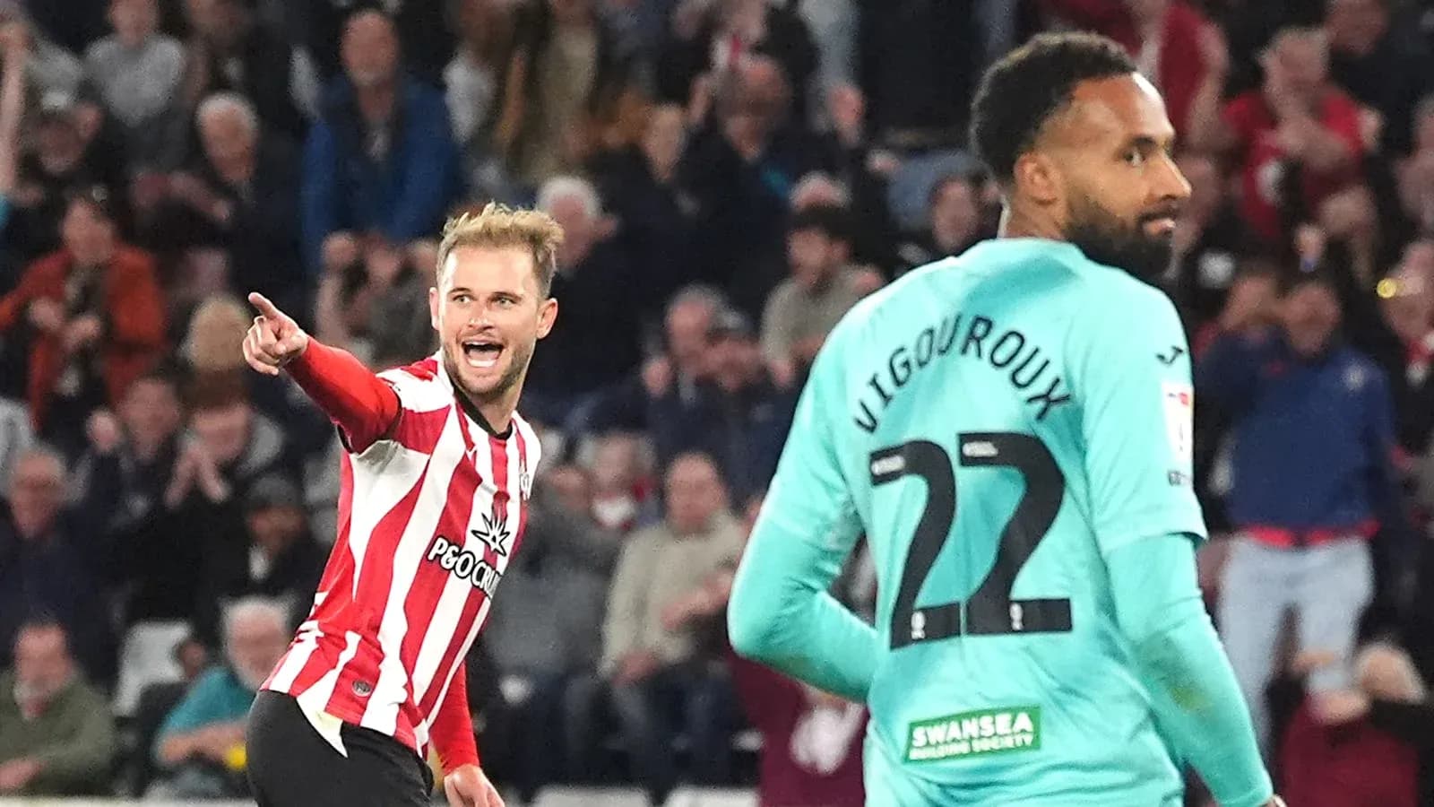 Player celebrating a goal while another looks on