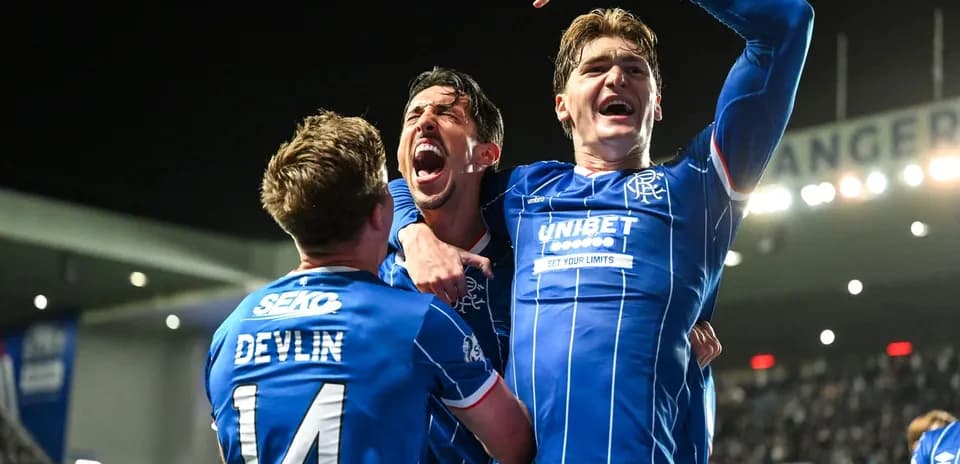 Rangers players celebrating a goal in stadium