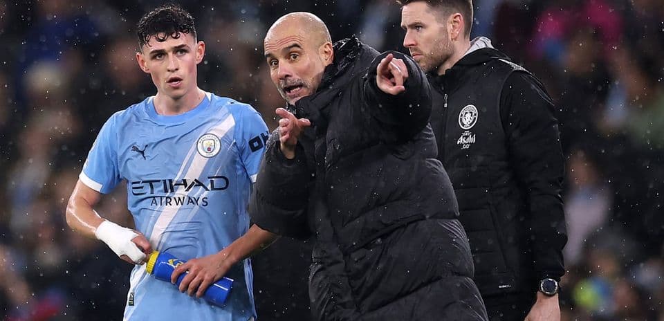 Pep Guardiola instructing player during match rain