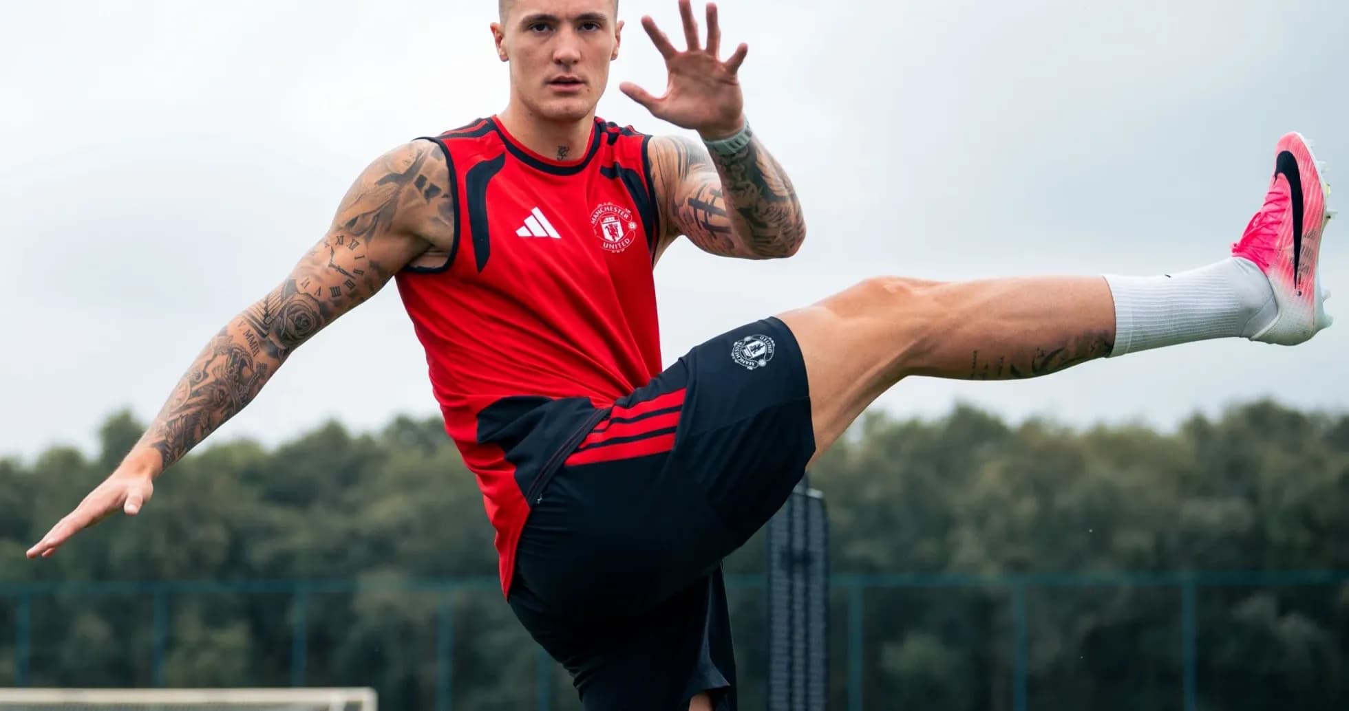 Player stretching leg during training session at pitch