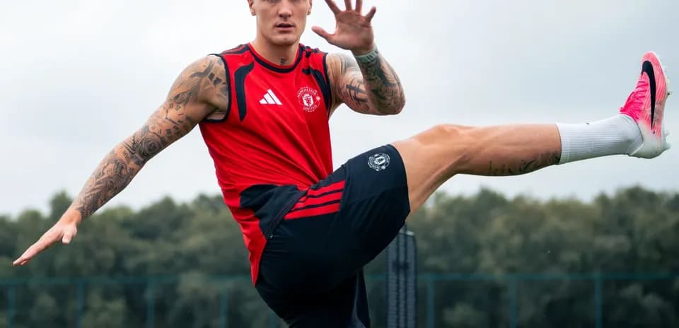 Player stretching leg during training session at pitch